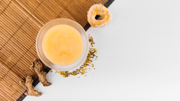 High angle view of ginger; lemon curd; bee pollen and donut