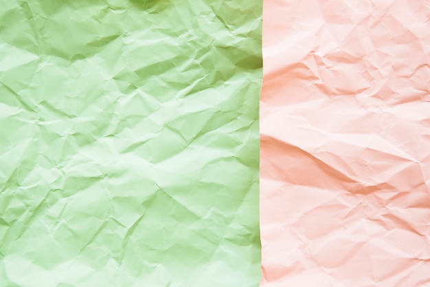 High angle view of green and pink crumpled paper surface