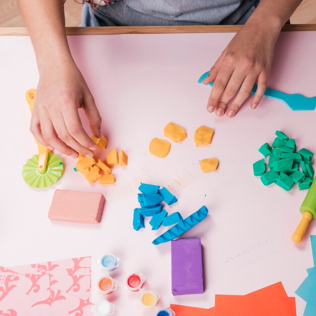 High angle view of hand holding colorful clay