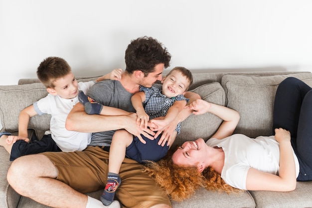 High angle view of happy family having fun on sofa