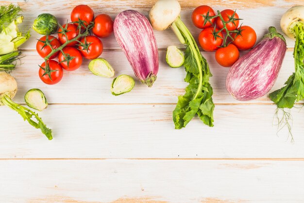 High angle view of healthy organic vegetables on wooden plank