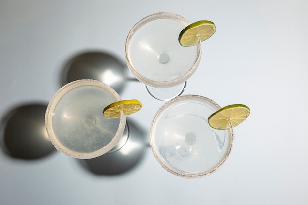 High angle view of homemade classic margarita drink with lime and salt on white table