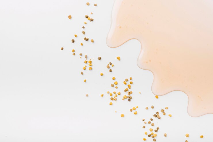 Free Photo high angle view of honey and bee pollen seeds on white background