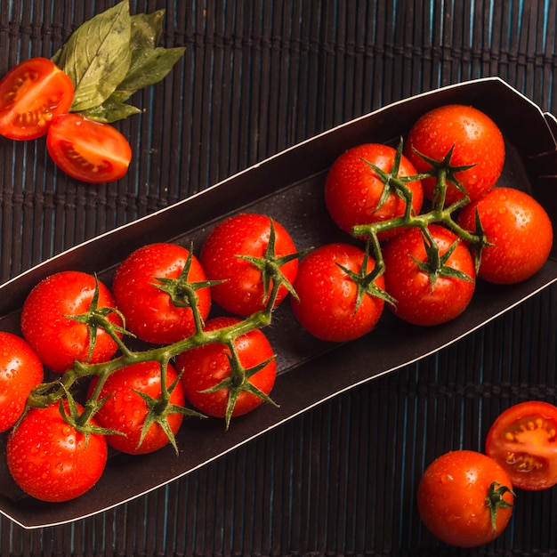 High angle view of juicy red tomatoes in tray