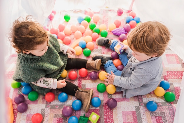 High angle view of kids sitting inside tepee