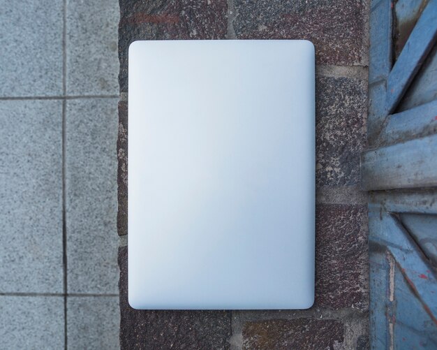 High angle view of a laptop on stone pavement