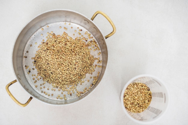 High angle view of lentils on white surface