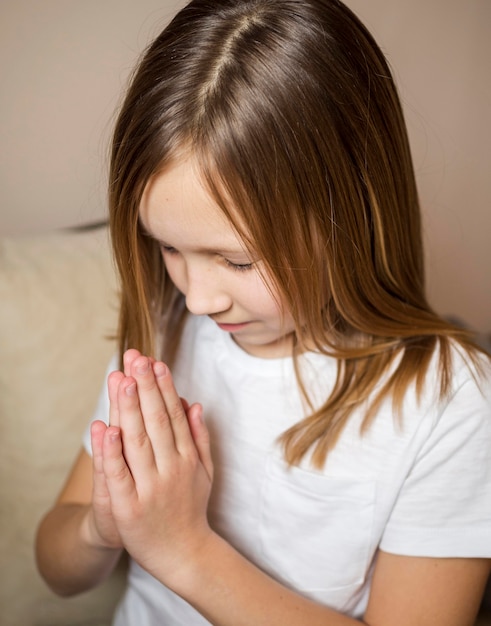 High angle view of little girl praying