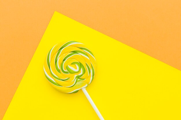 High angle view of lollipop on yellow layout