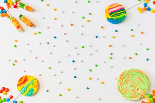 High angle view of lollipops and candies on white background