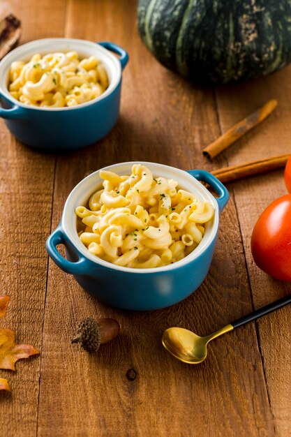 High angle view of macaroni bowls with autumn harvest