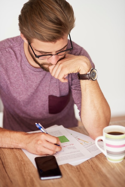 High angle view on man working over documents