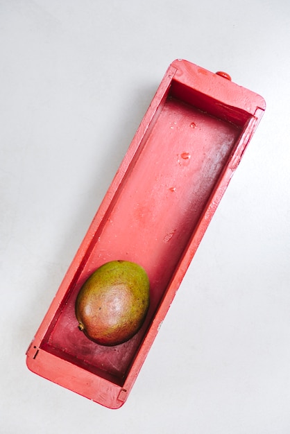 High angle view of mango in wooden container