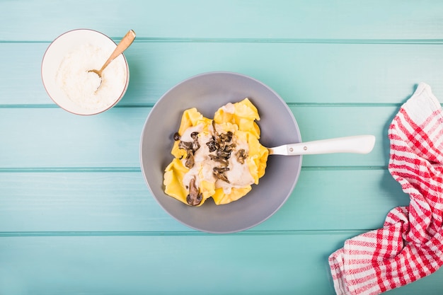 Free photo high angle view of pasta with edible mushroom on desk