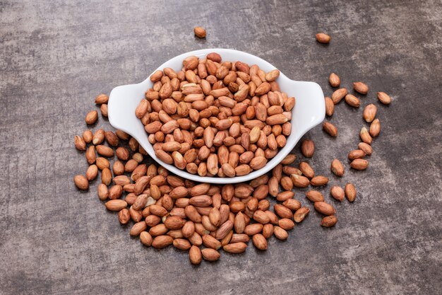 High angle view peanuts in bowl on stone horizontal