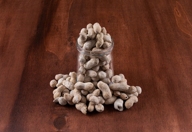 High angle view peanuts in a glass jar on horizontal