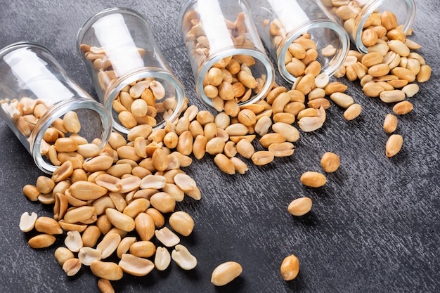 High angle view peanuts in jars on stone horizontal