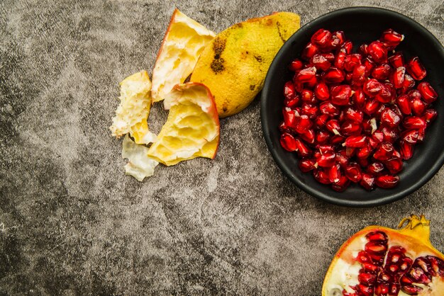 High angle view of pomegranate seeds and peel