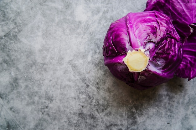 Free photo high angle view of purple cabbage on concrete background