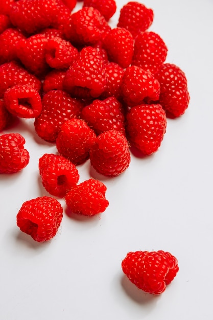 High angle view raspberries on white background. vertical