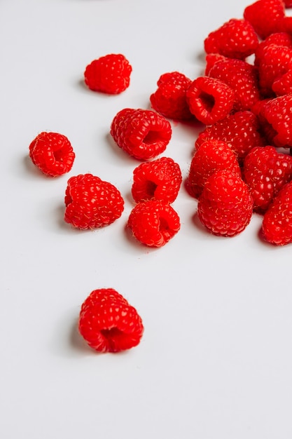 High angle view raspberries on white background. vertical