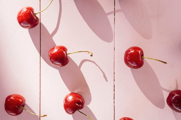 High angle view of red cherries on wooden plank