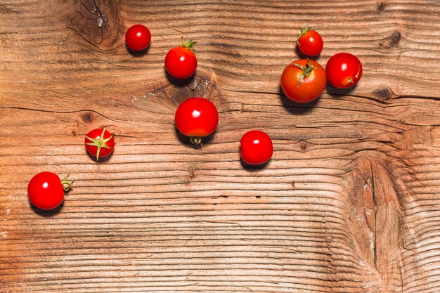 High angle view of red cherry tomatoes on wooden surface