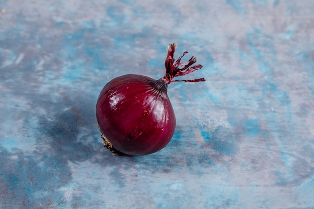 High angle view red onion on textured surface. horizontal