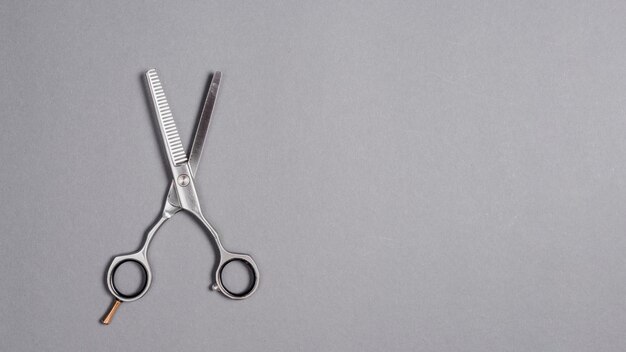 High angle view of a scissors on grey background