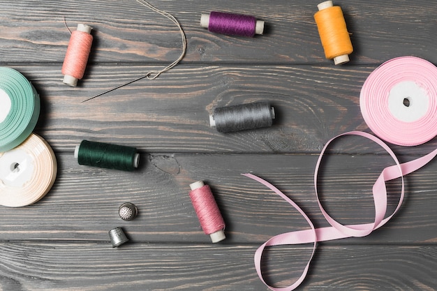 Free photo high angle view of sewing tool on wooden background