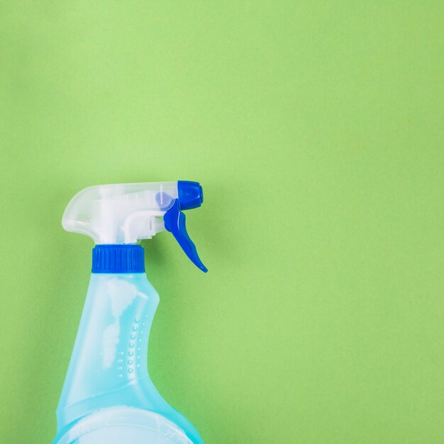High angle view of spray bottle on green background
