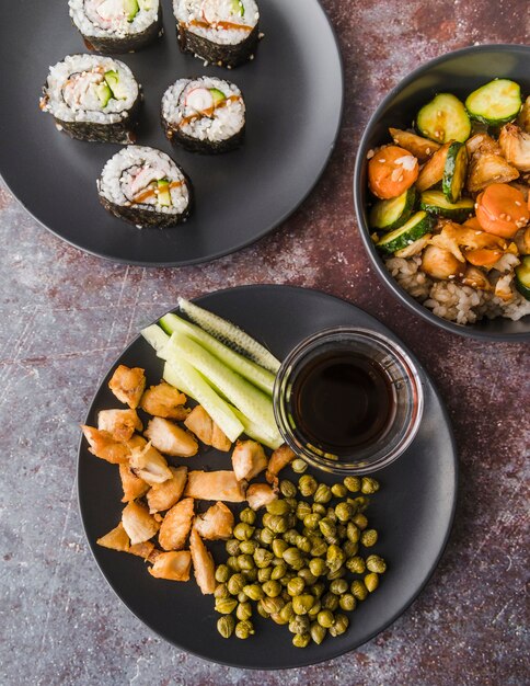 High angle view sushi with vegetables plates