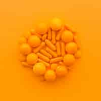 Free photo high angle view of sweet candies on orange surface