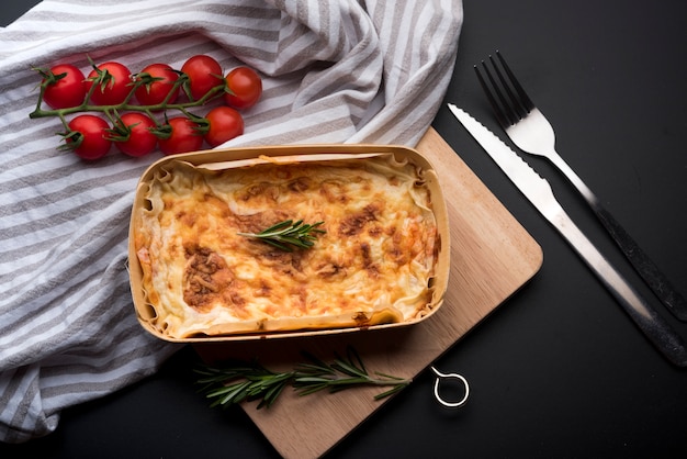 High angle view of tablecloth; fresh ingredient and delicious lasagna