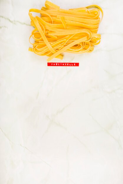 High angle view of tagliatelle pasta on marble