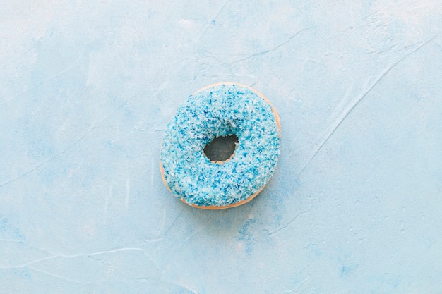 High angle view of tasty donut on blue background