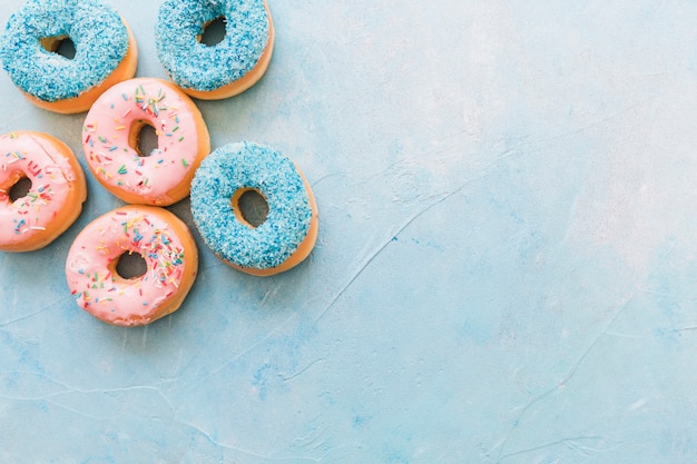 High angle view of tasty donuts on blue background