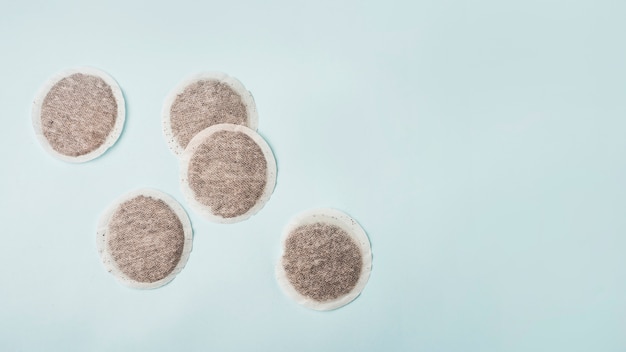 High angle view of tea bags on blue background