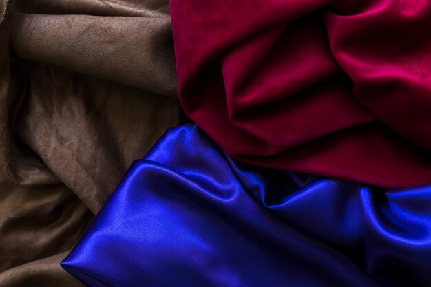 High angle view of three colorful silky drapes
