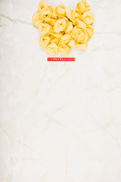 High angle view of tortellini pasta on marble