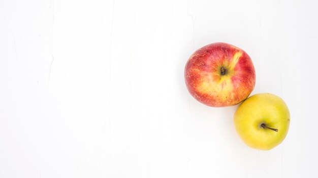 High angle view of two apples on white background