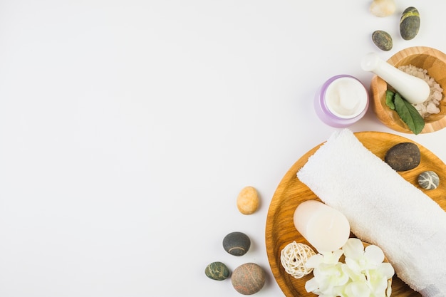 High angle view of various spa products on white backdrop