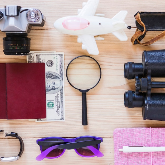 Free photo high angle view of various traveler accessories on wooden backdrop