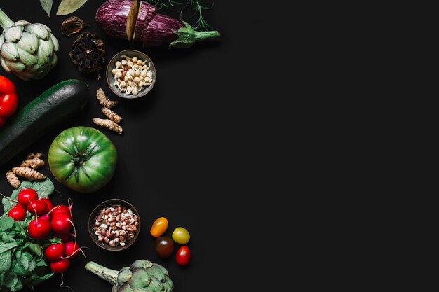 High angle view of various vegetables on black background