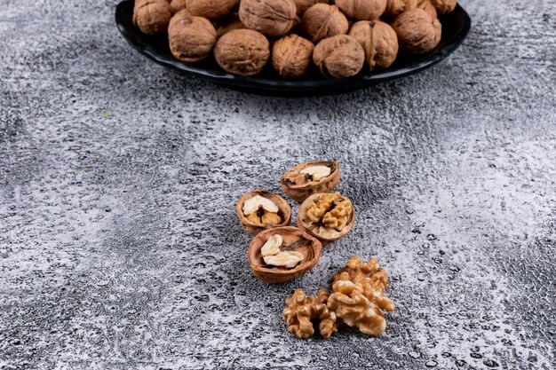 High angle view walnuts in plate on table horizontal