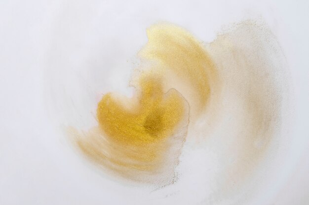 High angle view of white canvas with yellow paint stains