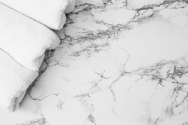 High angle view of white towels on marble backdrop