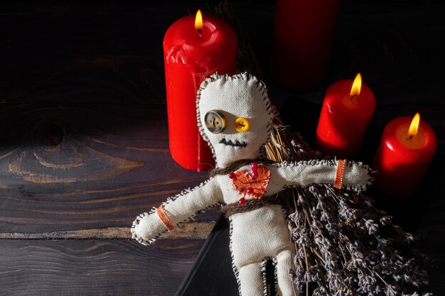 High angle vodoo doll and candles