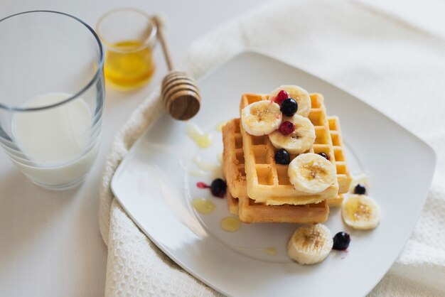 high angle of waffers and fruits on plate