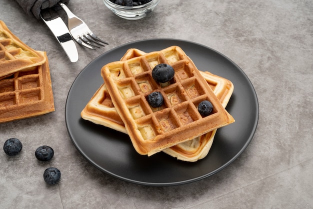 High angle of waffles on plate with blueberries